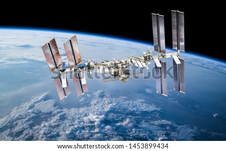 International space station on orbit of Earth planet. ISS. Dark background. Elements of this image furnished by NASA Royalty-Free Stock Photo #1453899434