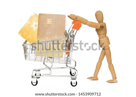 Wooden mannequins with miniature shopping cart and credit card running for sales on white background. Concept for shopping, discount, black friday, copy space, side view