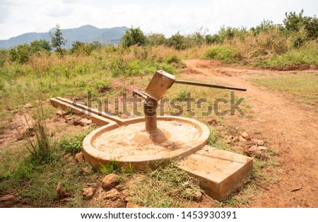Broken water pump in rural uganda Royalty-Free Stock Photo #1453930391