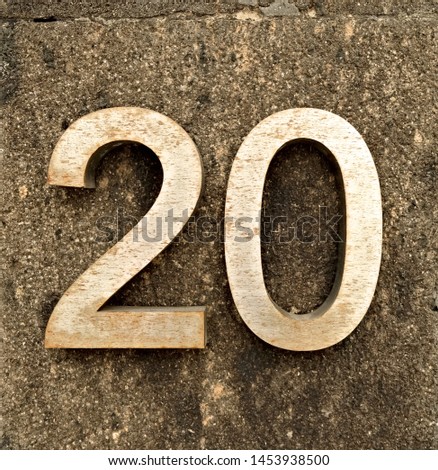 20, number twenty, metal digits on stone background.