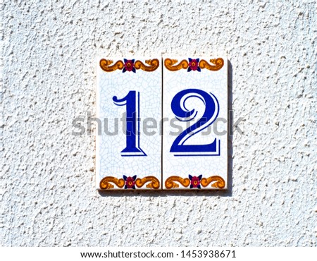Decorative tiles with home number 12 / twelve. 