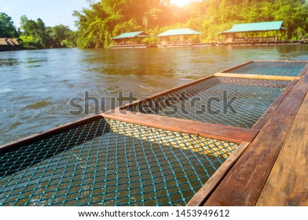 Seating net at the rafting cottage terrace  in the moring sunrise with pavilion flating of resort for tourist to relax on holiday at  Sai Yok river,Kanchanaburi,Thailand.