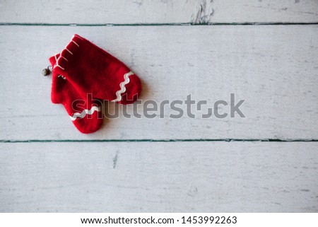 Red Mittens on White Wood Background