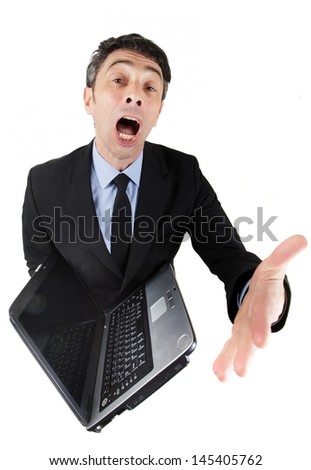 Humorous high angle full length portrait of a loquacious businessman with an open laptop with his mouth wide open and gesturing with his hand while giving a presentation Royalty-Free Stock Photo #145405762