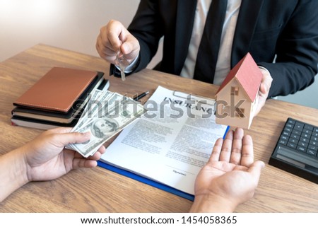 Real Estate broker or sale agent giving consultation to customer about buying house sign agreement document contract. Home loan 