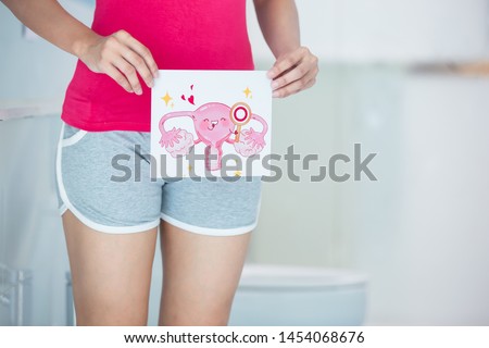 asian woman with cartoon womb billboard and feel good