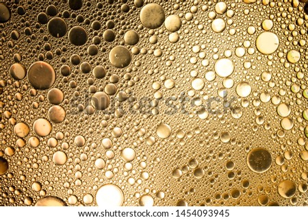 the glare on the texture of the bubbles solid background on the water