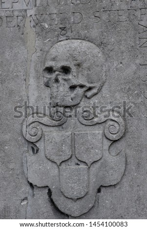 Human skull engraved on the wall of an old church. 