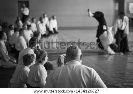 Aikido training. Black and white image. The teacher shows reception.  Traditional form of clothing in Aikido. Royalty-Free Stock Photo #1454126627