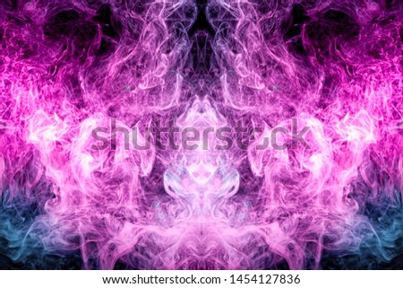 Thick colorful smoke of blue, pink in the form of a skull, monster, dragon on a black isolated background. Background from the smoke of vape. Mocap for cool t-shirts
