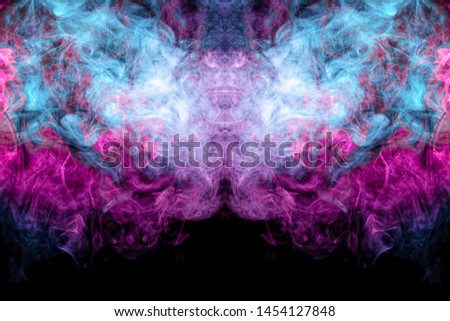 Cloud of blue and pink smoke  in the form of a skull, monster, dragon  on a black isolated background. Background from the smoke of vape. Mocap for cool t-shirts
