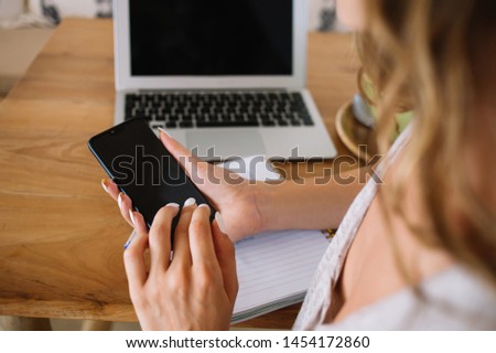 Selective focus on blank smartphone gadget with mockup screen for internet website used by millennial woman for research information, modern mobile phone with copy space area for advertising text