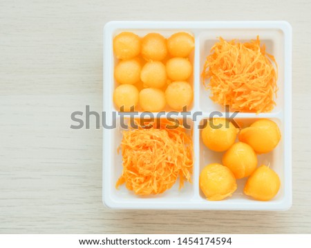 A picture of traditional Thai dessert, golden egg yolks drops, golden threads, bean-paste, 