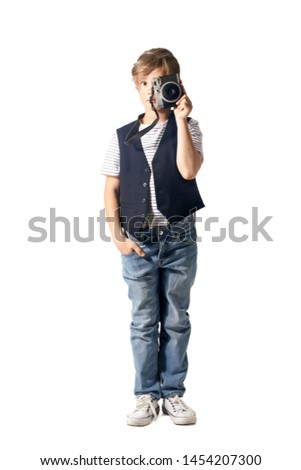 Cute little photographer with professional camera on white background