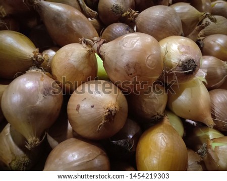Orange Onion texture. Fresh onion on market. Vitamin healthy food spice image. Spicy cooking ingredient picture. Pile of Orange Onion heads. Orange Onion head heap top view