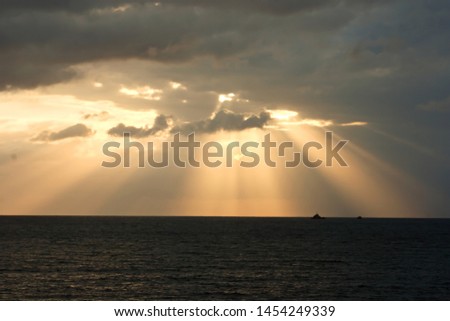 sunset in Ibiza, sunbeams in the sea, dawn in Ibiza,with some clouds on the horizon, golden yellow sun and golden sun wake in the sea, a calm Mediterranean Sea, Ibiza, Formentera, Pitiusas,
