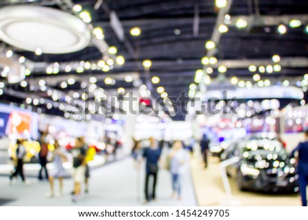 abstract blurred people in motor show or cars exhibition