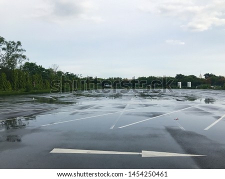 empty outdoor parking lot at rainy day Royalty-Free Stock Photo #1454250461