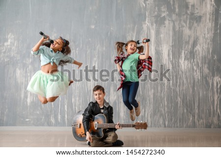 Band of little musicians against grunge wall