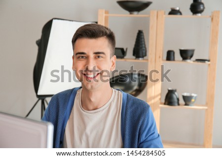 Male photographer working on computer in studio