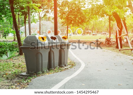 Category Recycle Bin Various For Clean And Good Environment With Background Bicycle In Public Park  With Sunlight.