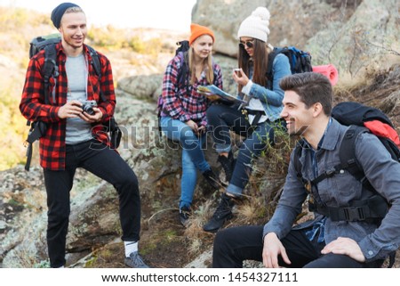 Photo of happy young group of friends outside in free alternative vacation camping.