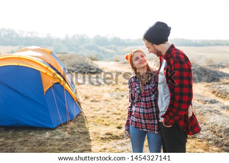Photo of happy young loving couple outside in free alternative vacation camping over mountains.
