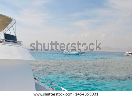 View from the yacht to the yacht in the open sea.  Blue sky and water.  Coral reefs in the sea Royalty-Free Stock Photo #1454353031