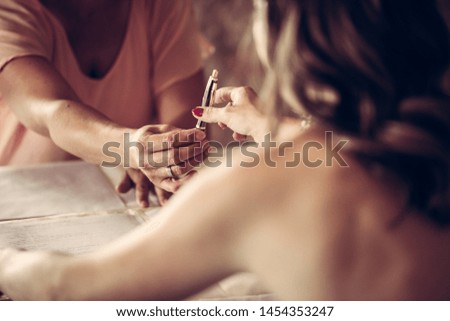 Bride signs forms at her wedding