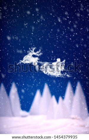 Steam in reindeer and Santa Claus into sled shape flying in snowy landscape. Christmas or New Year celebration concept. Copy space