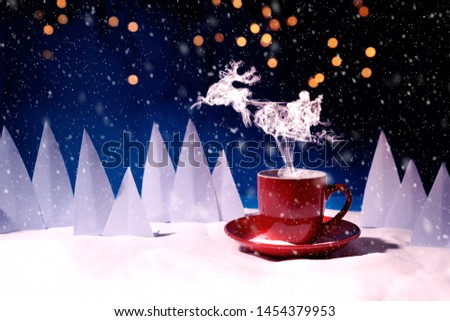 Steam in reindeer and Santa Claus into sled shape flying over red mug of coffee or tea in snowy landscape. Christmas or New Year celebration concept. Copy space