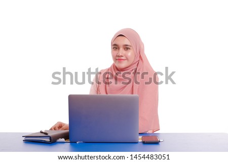Pretty young  woman wearing hijab in front of laptop search and doing office work with different face expression isolated in white background - Office, business, finance and work station concept .