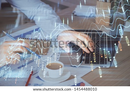 Forex graph with businessman working on computer in office on background. Concept of hardworking. Multi exposure.