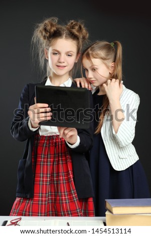 Busy children studying with digital laptop and tablet inside the school