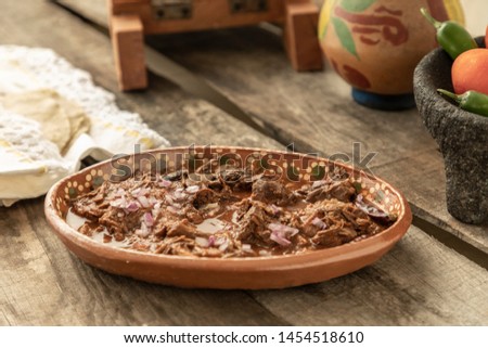 Plate with delicious birria on a rustic table. Mexican traditional dish.