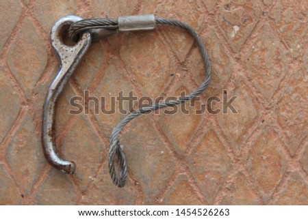 The wire rope that is broken is placed on the background of Thai sandstone pattern.