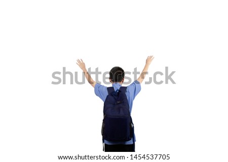 ฺฺBoy in the school uniform with backpack stood back.Standing, facing the back, holding both hands. isolated on white background.