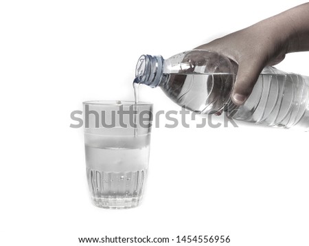 Close-up pouring purified fresh drink water from the bottle isolated on white background
