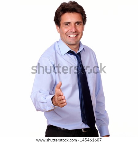 Portrait of an smiling adult man extending handshake at you against white background