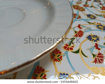 
Ornate dinner plate with floral motifs. Photo.
