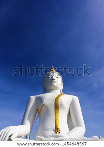 White Buddha statue, golden sash, blue cloud