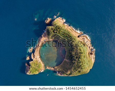Azores aerial panoramic view. Top view of Islet of Vila Franca do Campo. Crater of an old underwater volcano. San Miguel island, Azores, Portugal. Heart carved by nature. Bird eye view. Royalty-Free Stock Photo #1454652455