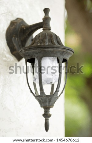 A street lamp on the wall of the house