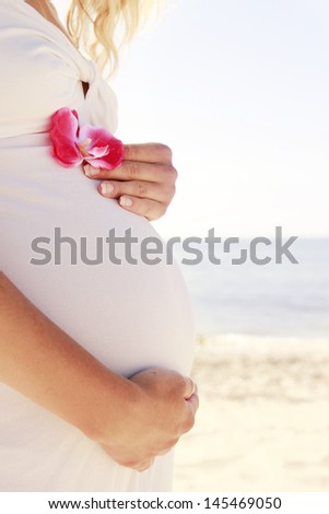 belly pregnant woman on the beach