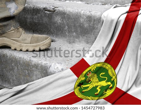 Military concept on the background of the flag of Alderney