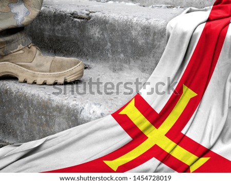 Military concept on the background of the flag of Guernsey