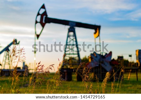 Oil pump. Oil industry equipment in a rape chain. oil pumps in Russia. Oil production. Summer