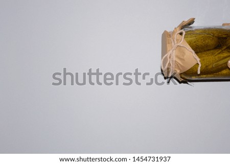 pickles cucumbers in a jar on a light background tasty tradition free place