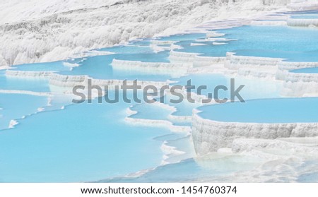 Beautiful natural travertine pools and terraces view from Pamukkale, Denizli, Turkey. Cotton castle at sunny bright day.