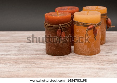 Romantic and scented candles on old wooden background